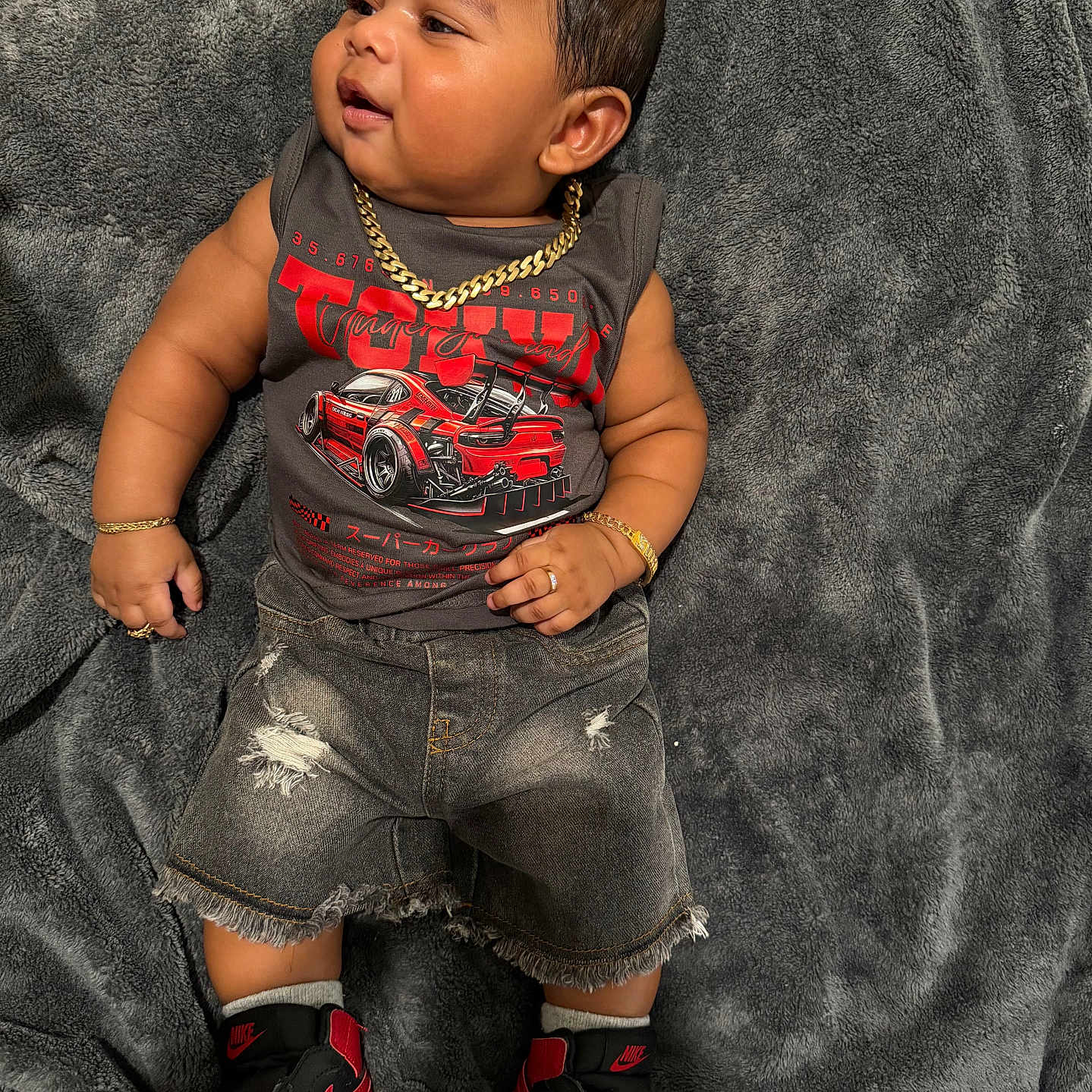 Sulenny joined the competition — help win amazing prizes! baby, child, infant, blanket, gray_blanket, clothing, tank_top, graphic_tshirt, ripped_shorts, denim_shorts, sneakers, nike, jewelry, gold_chain, bracelet, ring, footwear, cute, indoors, portrait