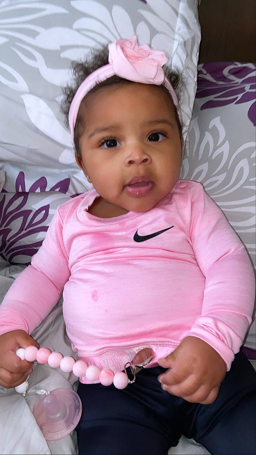 Maliah is registered to the contest to win money with this photo: baby, baby_toddler_clothing, cheek, child, eye, eyebrow, eyelash, face, facial_expression, happy, iris, lip, magenta, mouth, person, pink, skin, sleeve, smile, toddler