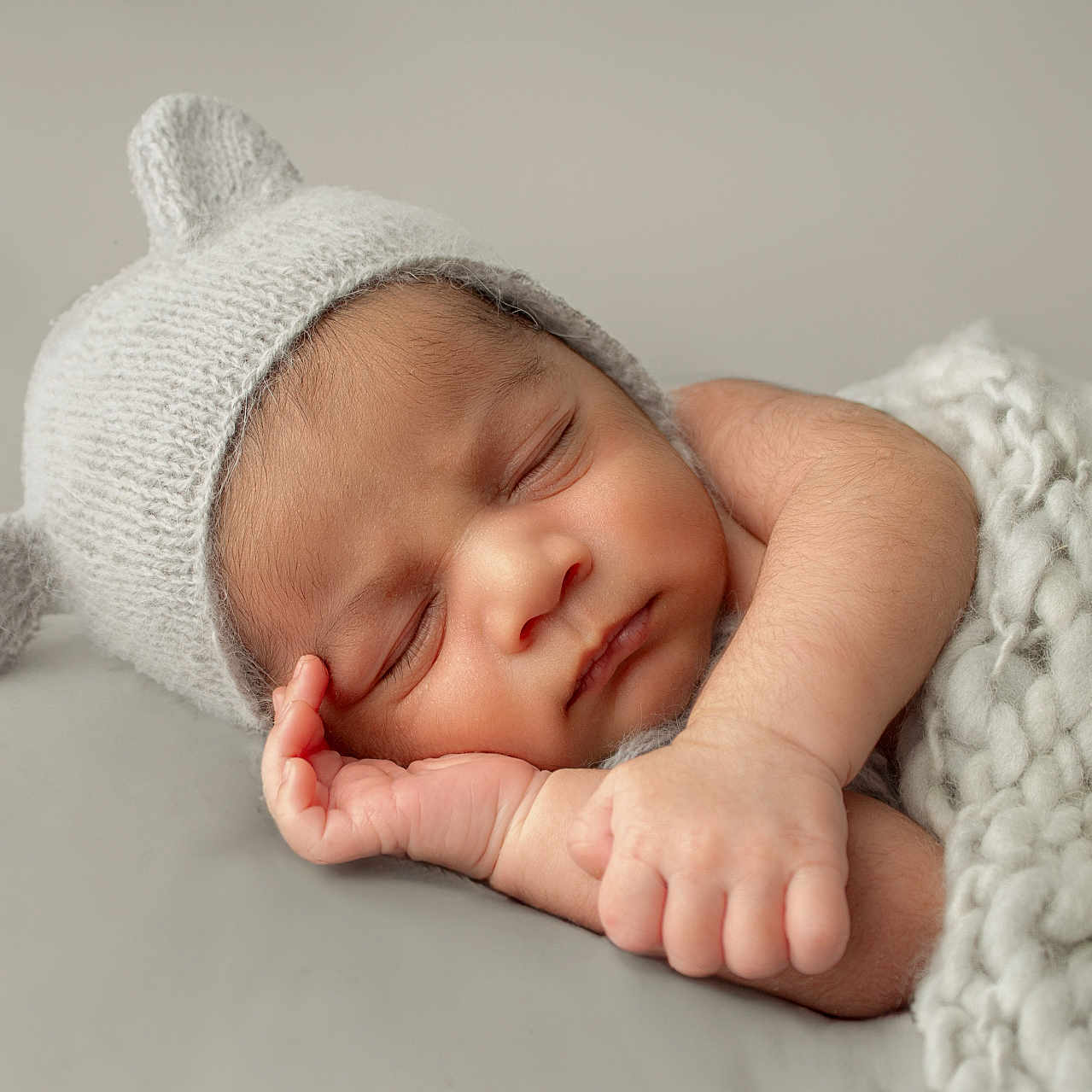 Nirvaan is registered to the contest to win money with this photo: baby, beanie, bodypart, bonnet, cap, clothing, face, finger, hand, hat, head, newborn, person, photography, portrait, sleeping