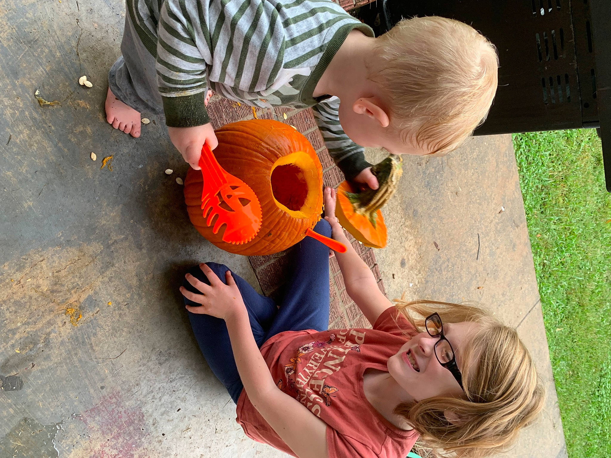 Jon is registered to the contest to win money with this photo: adaptation, clothing, fun, grass, guitar, happy, hat, joy, leisure, musical_instrument, orange, person, plant, recreation, shoe, sneakers, string_instrument, summer, sunglasses, t_shirt