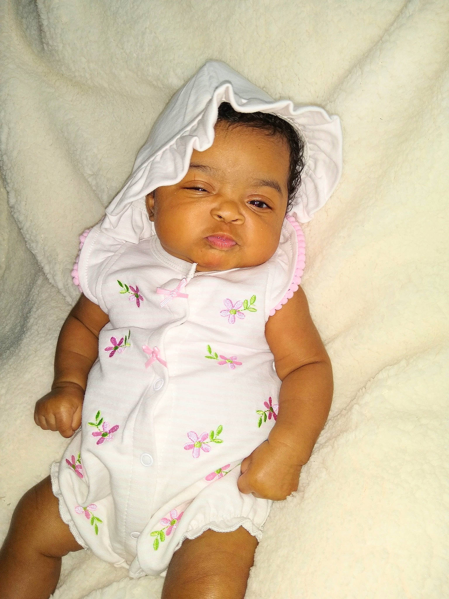 June is registered to the contest to win money with this photo: baby, baby_products, baby_toddler_clothing, cheek, child, collar, comfort, dress, eye, face, hat, linens, lip, pattern, person, pink, sitting, skin, sleeve, textile