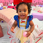 Willow joined the competition — help win amazing prizes! baby, celebration, child, colorful, curly_hair, cute, dress, fun, happy, indoor, people, pink_ball, play_area, portrait, red_bow, smiling, snow_white_costume, toddler, toys, young_child