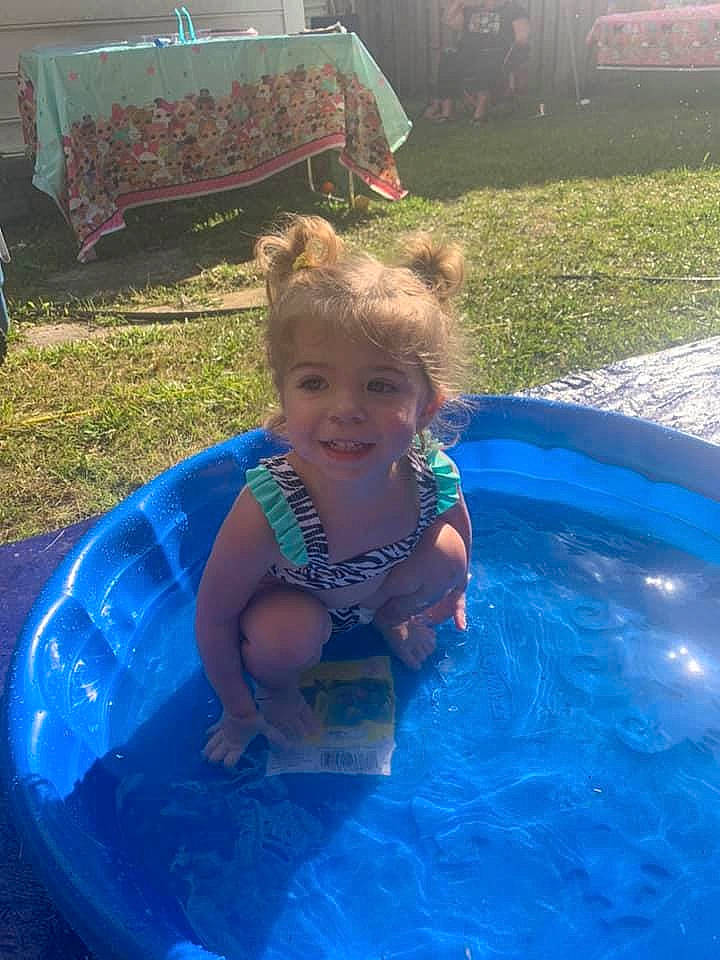 Cameryn is registered to the contest to win money with this photo: aqua, azure, bathing, blue, child, fluid, fun, grass, green, happy, head, joy, leisure, light, person, photograph, product, recreation, smile, summer