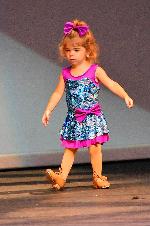 Cameryn joined the competition — help win amazing prizes! blond, child, day_dress, dress, electric_blue, entertainment, event, fashion_design, flooring, happy, human_leg, magenta, one_piece_garment, pattern, performing_arts, person, pink, purple, recreation, toddler