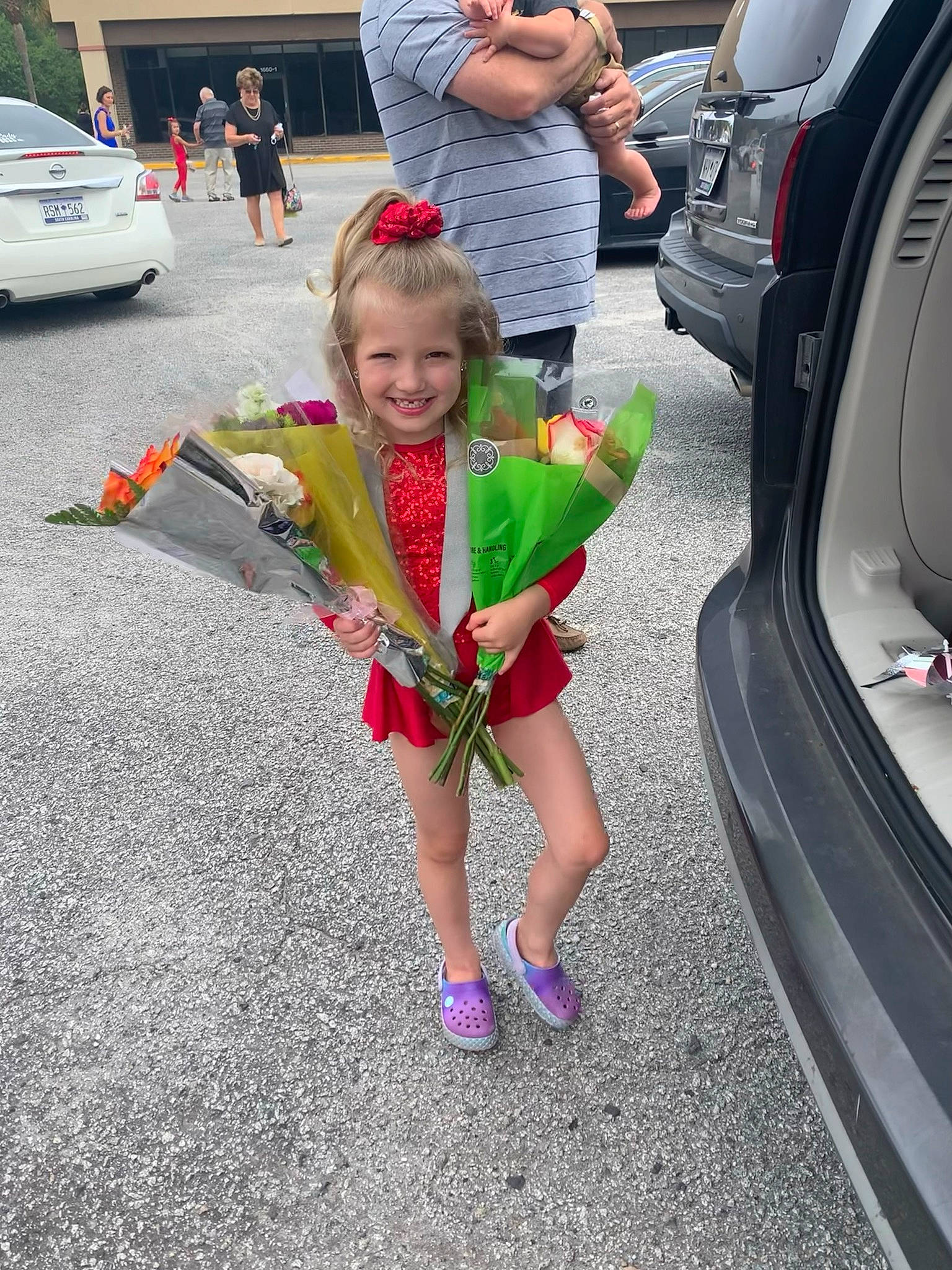 Ashtyn joined the competition — help win amazing prizes! asphalt, automotive_design, automotive_lighting, automotive_tire, bumper, car, clothing, dress, joy, leisure, motor_vehicle, person, plant, shoe, shorts, sneakers, tire, toy, trunk, vehicle