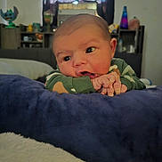 Farran joined the competition — help win amazing prizes! baby, infant, child, portrait, face, eyes, hands, curious, cozy, blanket, bed, green_sweater, indoors, bedroom, window, curtains, shelves, lava_lamp, home, photography