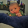 baby, infant, child, portrait, face, eyes, hands, curious, cozy, blanket, bed, green_sweater, indoors, bedroom, window, curtains, shelves, lava_lamp, home, photography