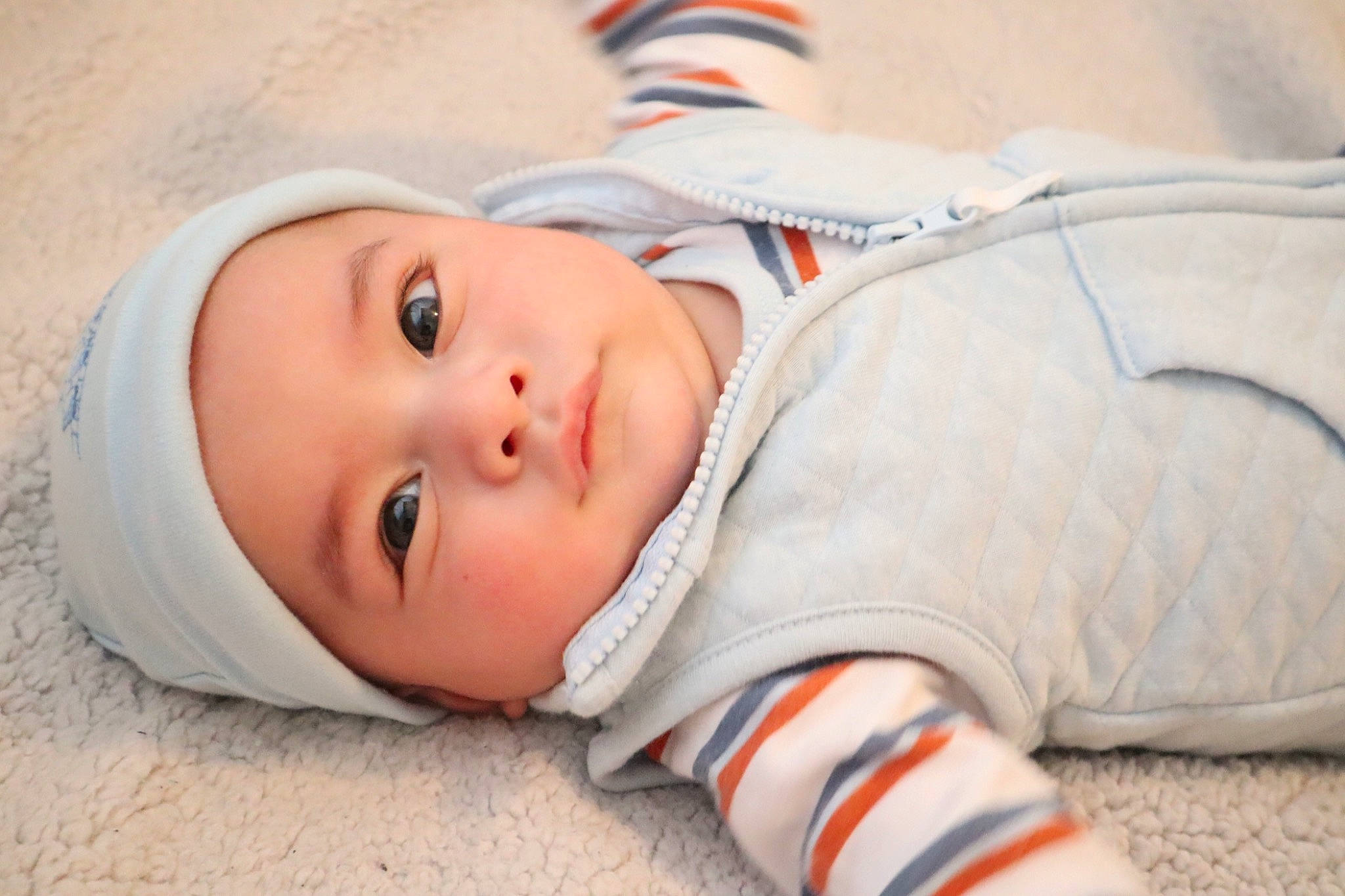 Jasiah is registered to the contest to win money with this photo: baby, baby_toddler_clothing, cheek, child, chin, close_up, comfort, eye, face, fun, grass, happy, headwear, human_body, lip, nose, orange, person, skin, sleeve