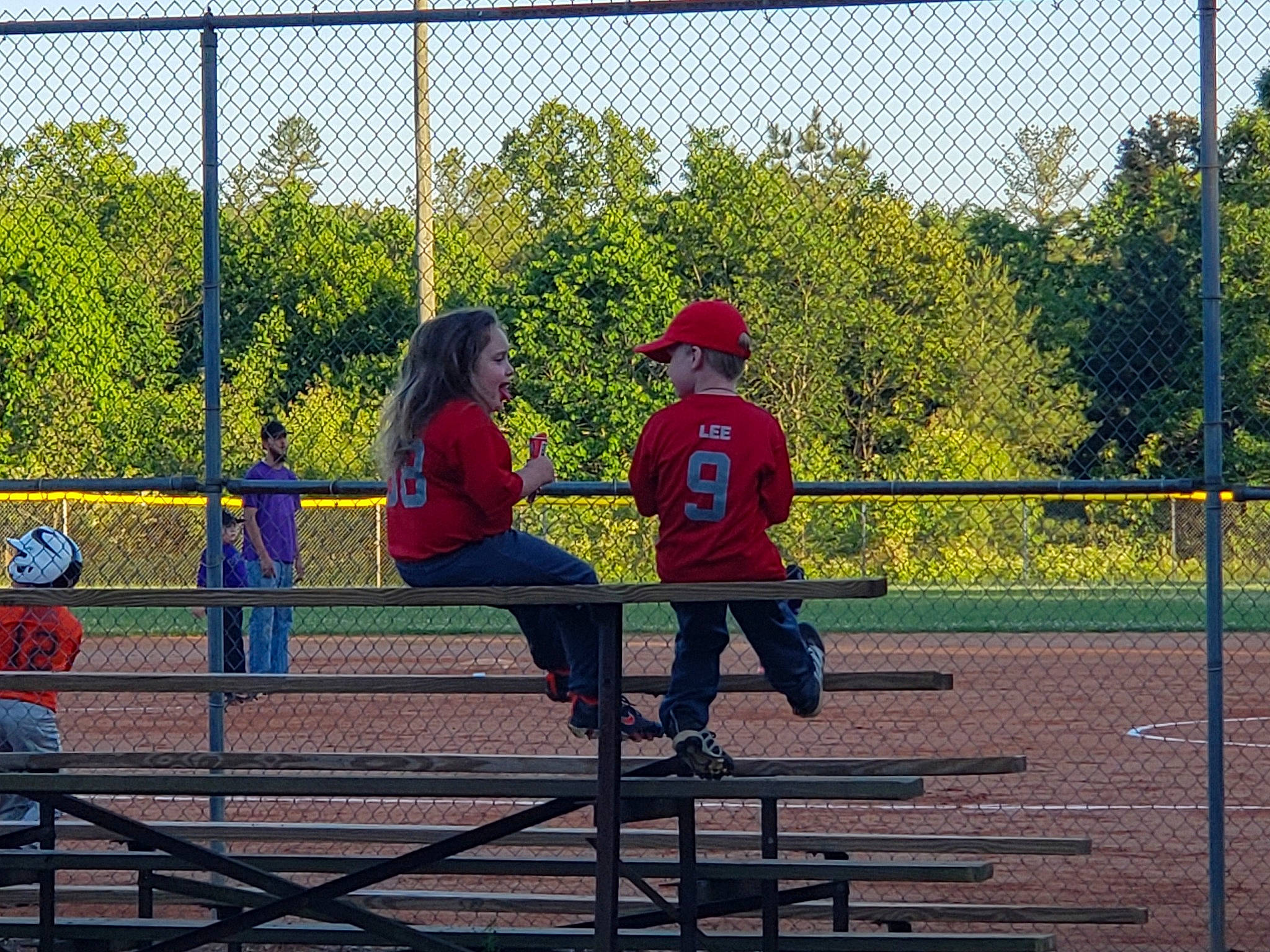 Kenslie is registered to the contest to win money with this photo: baseball, baseball_equipment, baseball_field, bat_and_ball_games, chain_link_fencing, competition_event, fence, fun, leisure, person, play, player, playground, public_space, recreation, softball, sport_venue, sports, sports_equipment, team