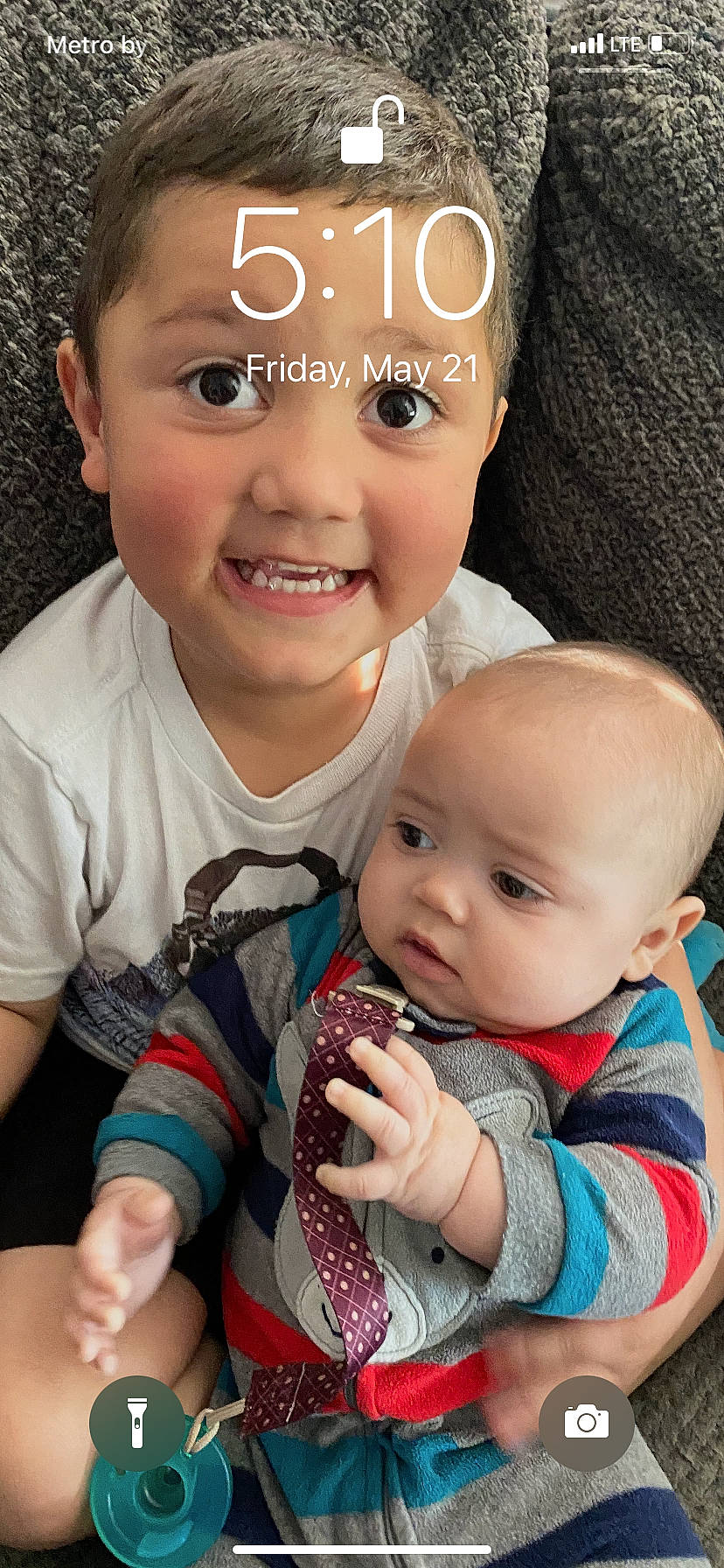 Creed is registered to the contest to win money with this photo: arm, baby_toddler_clothing, cheek, chin, eye, face, facial_expression, hand, head, human, lip, mouth, nose, organ, person, photograph, product, skin, sleeve, smile