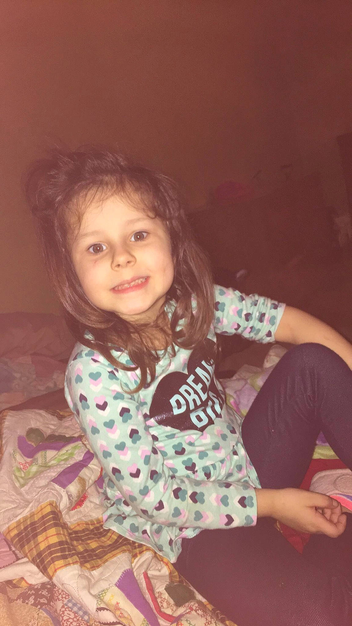 Nakia is registered to the contest to win money with this photo: arm, brown_hair, cheek, child, child_model, eye, face, forehead, fun, happy, head, iris, long_hair, nose, person, pink, sitting, skin, smile, toddler