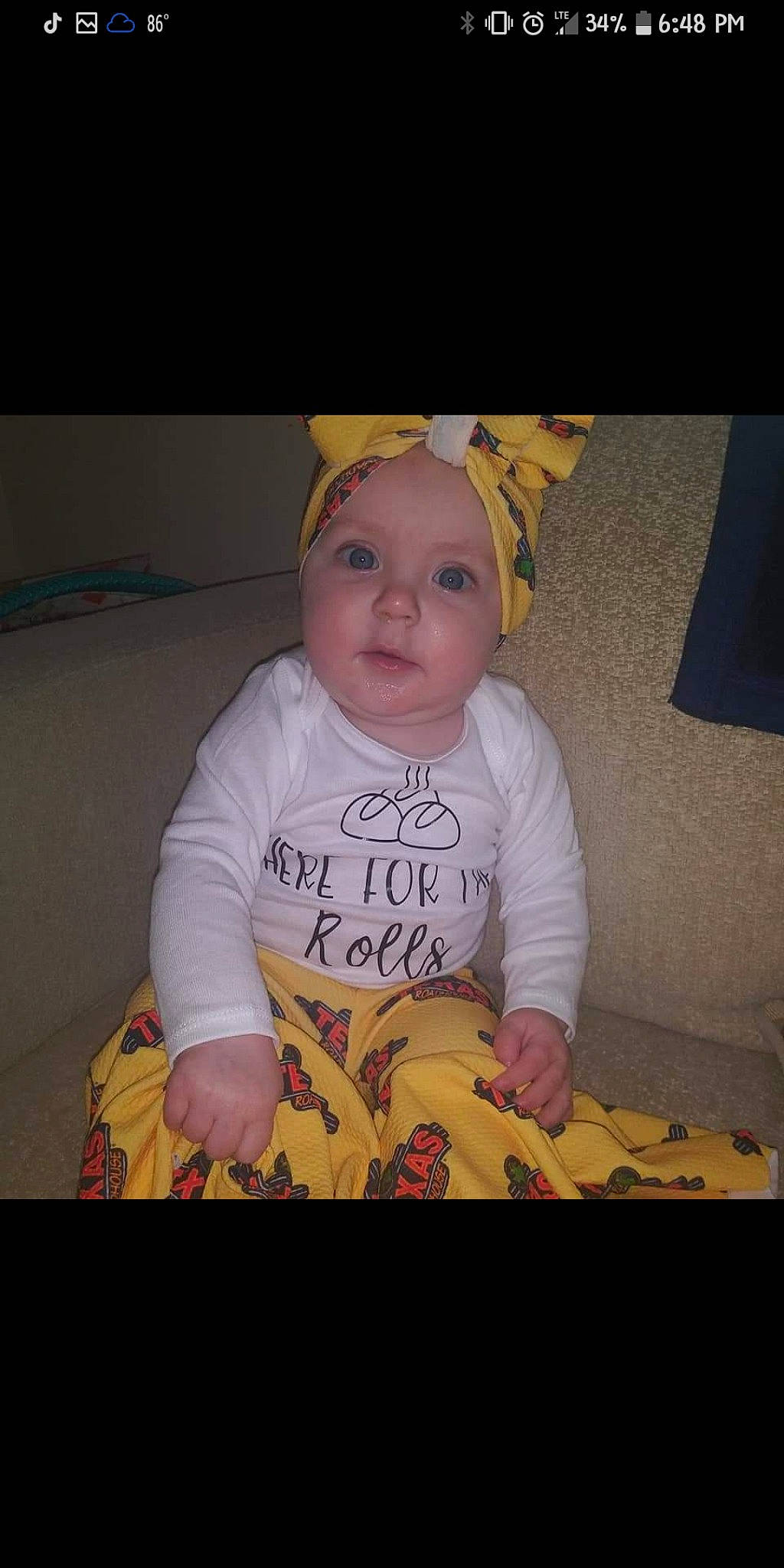 Emilee is registered to the contest to win money with this photo: baby, baby_products, baby_toddler_clothing, cap, cheek, child, cool, flooring, fun, happy, iris, mouth, pattern, person, photo_caption, room, sitting, skin, sleeve, t_shirt