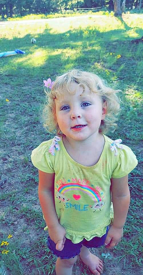 Brealee is registered to the contest to win money with this photo: baby_toddler_clothing, botany, child, clothing, face, fun, grass, grass_family, happy, iris, leaf, people_in_nature, person, pink, plant, recreation, skin, smile, t_shirt, toddler