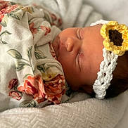 Kinsley is registered to the contest to win money with this photo: newborn, baby, sleeping, blanket, floral, headband, flower, crochet, soft, texture, closeup, portrait, infant, peaceful, wrapped, warm, cute, rest, child, cozy