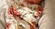Kinsley is registered to the contest to win money with this photo: baby, blanket, child, cozy, crocheted, cushion, cute, floral_pattern, flower, headband, indoors, infant, newborn, peaceful, portrait, resting, sleepy, smile, soft, wrapped