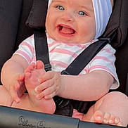 Ariya joined the competition — help win amazing prizes! baby, smiling, blue_eyes, headband, heart_decoration, stroller, car_seat, happy, child, infant, cute, clothing, stripes, foot, hand, person, seatbelt, black_background, pink, white