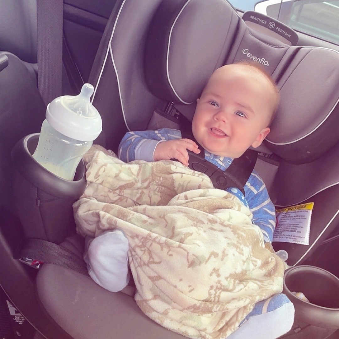 Cameron joined the competition — help win amazing prizes! baby, car_seat, blanket, bottle, smile, child, infant, seatbelt, car, window, clothing, happy, sitting, interior, automobile, safety, cute, young, person, transportation