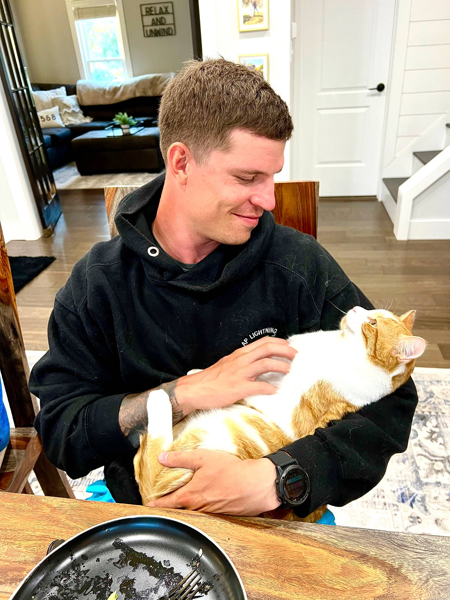 Sherby is registered to the contest to win money with this photo: automotive_tire, carnivore, cat, chair, comfort, companion_dog, cooking, cuisine, domestic_short_haired_cat, door, drink, felidae, lap, plate, sitting, small_to_medium_sized_cats, smile, tableware, whiskers, wood