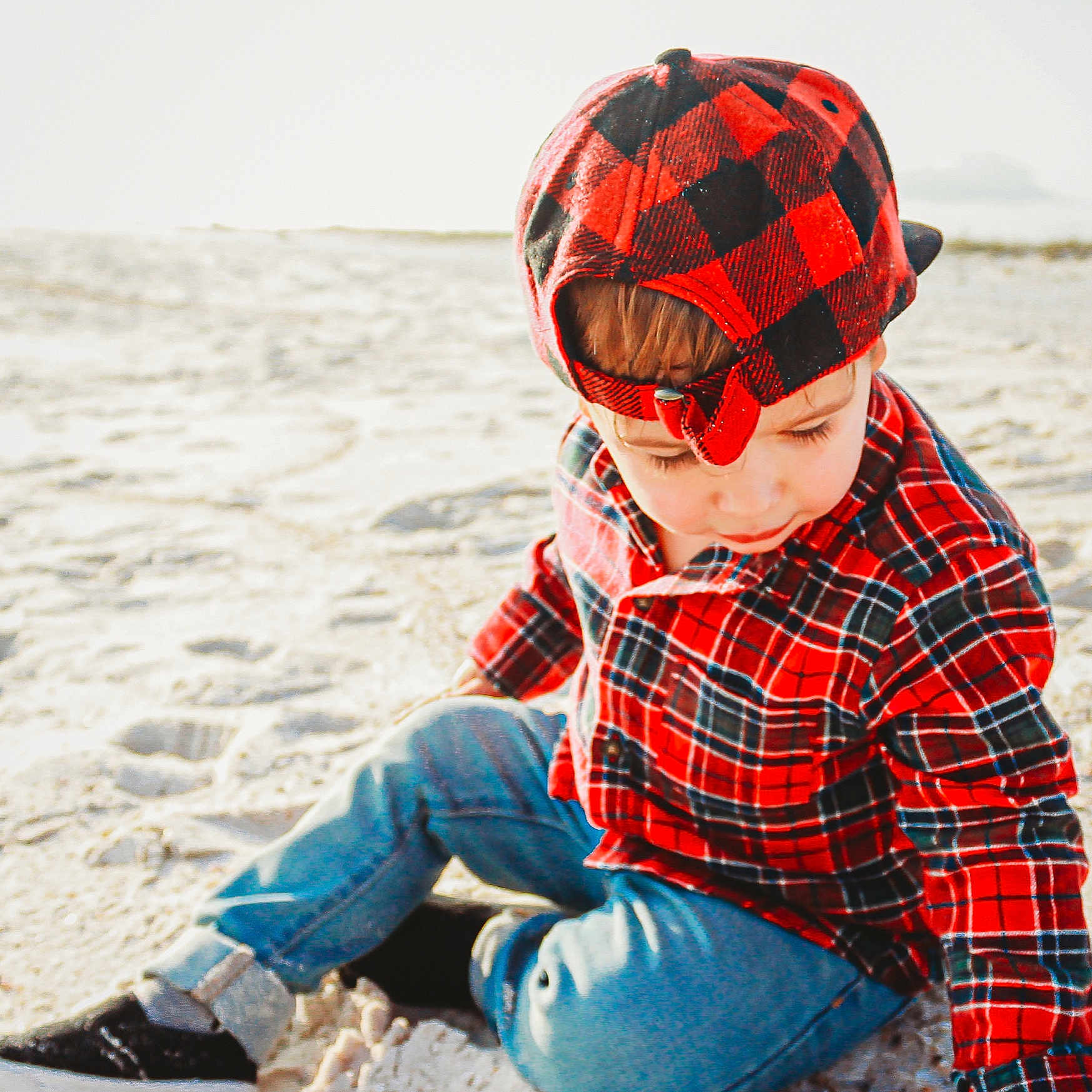 Roy joined the competition — help win amazing prizes! cap, child, cool, design, eyewear, fun, glasses, headgear, helmet, outerwear, pattern, personal_protective_equipment, plaid, sand, sitting, sunglasses, tartan, textile, toddler, vacation