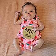 Celine joined the competition — help win amazing prizes! baby, infant, one_month, pink_clothing, strawberry_pattern, wooden_sign, lying_down, blanket, cute, small_hands, small_feet, face, eyes, expression, newborn, child, portrait, indoors, soft_texture, baby_girl