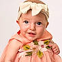 Maisie is registered to the contest to win money with this photo: baby, child, headband, bow, dress, embroidered_flowers, smile, happy, portrait, cute, infant, skin, face, eyes, hand, tulle, pink, peach, studio, soft_background