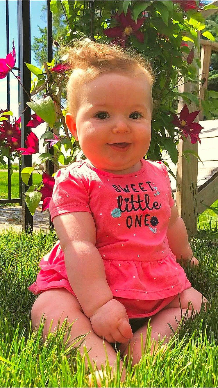 Cheyanne joined the competition — help win amazing prizes! baby, baby_toddler_clothing, cheek, child, facial_expression, fun, garden, grass, happy, lip, person, pink, plant, sitting, skin, smile, summer, toddler, vacation