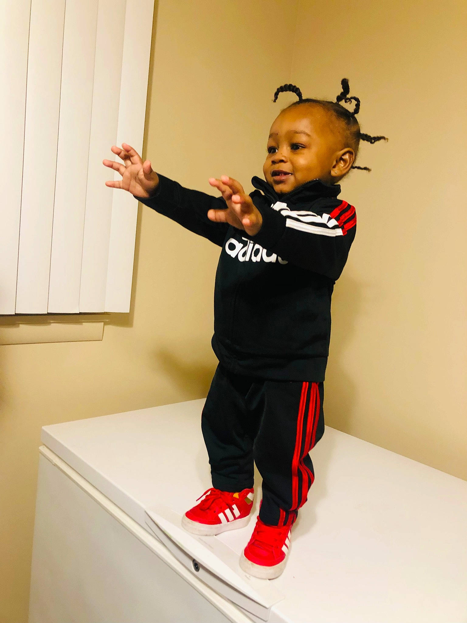 Jaiden is registered to the contest to win money with this photo: art, baby, baby_toddler_clothing, carmine, child, clothing, elbow, fashion_design, flooring, fun, gesture, happy, joint, knee, person, room, sleeve, sportswear, standing, t_shirt