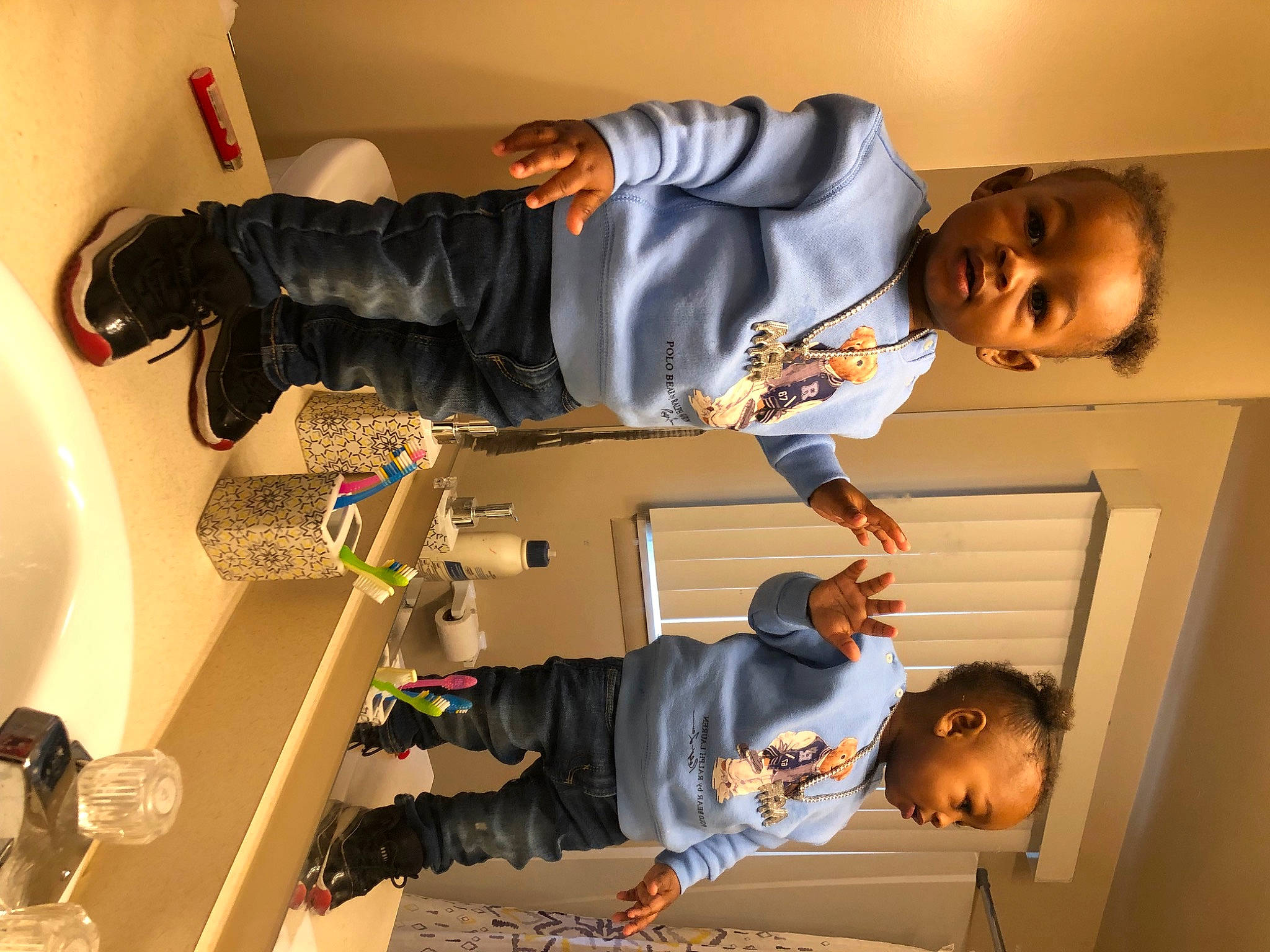 Jaiden is registered to the contest to win money with this photo: arm, ceiling, child, clothing, elbow, finger, fun, gesture, happy, organ, person, room, sleeve, smile, snapshot, sneakers, t_shirt, toddler, walking_shoe, white