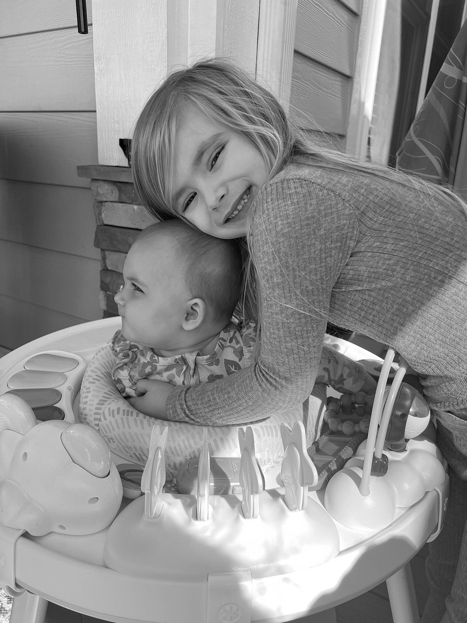 Raegan is registered to the contest to win money with this photo: baby, baby_carriage, baby_products, baby_toddler_clothing, black, black_and_white, chair, child, comfort, hairstyle, happy, joy, monochrome, monochrome_photography, person, room, sitting, smile, stock_photography, style