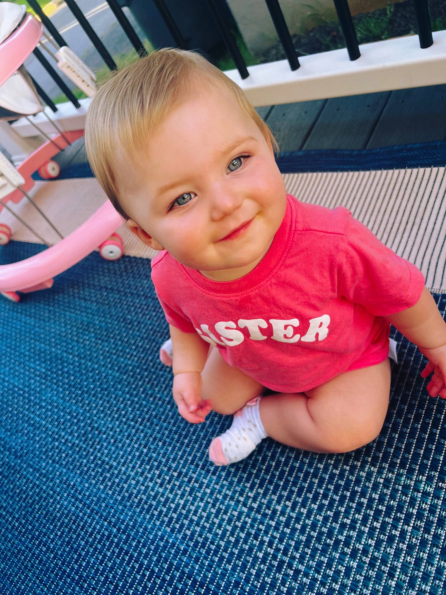 Harlyn joined the competition — help win amazing prizes! baby, baby_toddler_clothing, bookcase, cheek, finger, floor, flooring, grass, happy, head, human_body, joy, leg, leisure, nose, person, pink, skin, smile, thumb