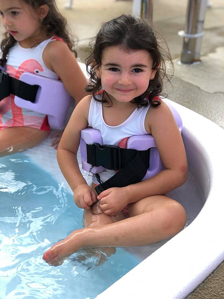 Asia is registered to the contest to win money with this photo: beauty, child, clothing, face, fun, games, hair, happy, head, headwear, joy, leisure, person, play, recreation, shorts, skin, smile, swimming_pool, swimwear