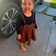 Nevaeh is registered to the contest to win money with this photo: toddler, child, smiling, barefoot, dress, bow, car, wheel, concrete, outdoor, sunlight, happy, person, clothing, sidewalk, grass, daylight, cute, young, standing
