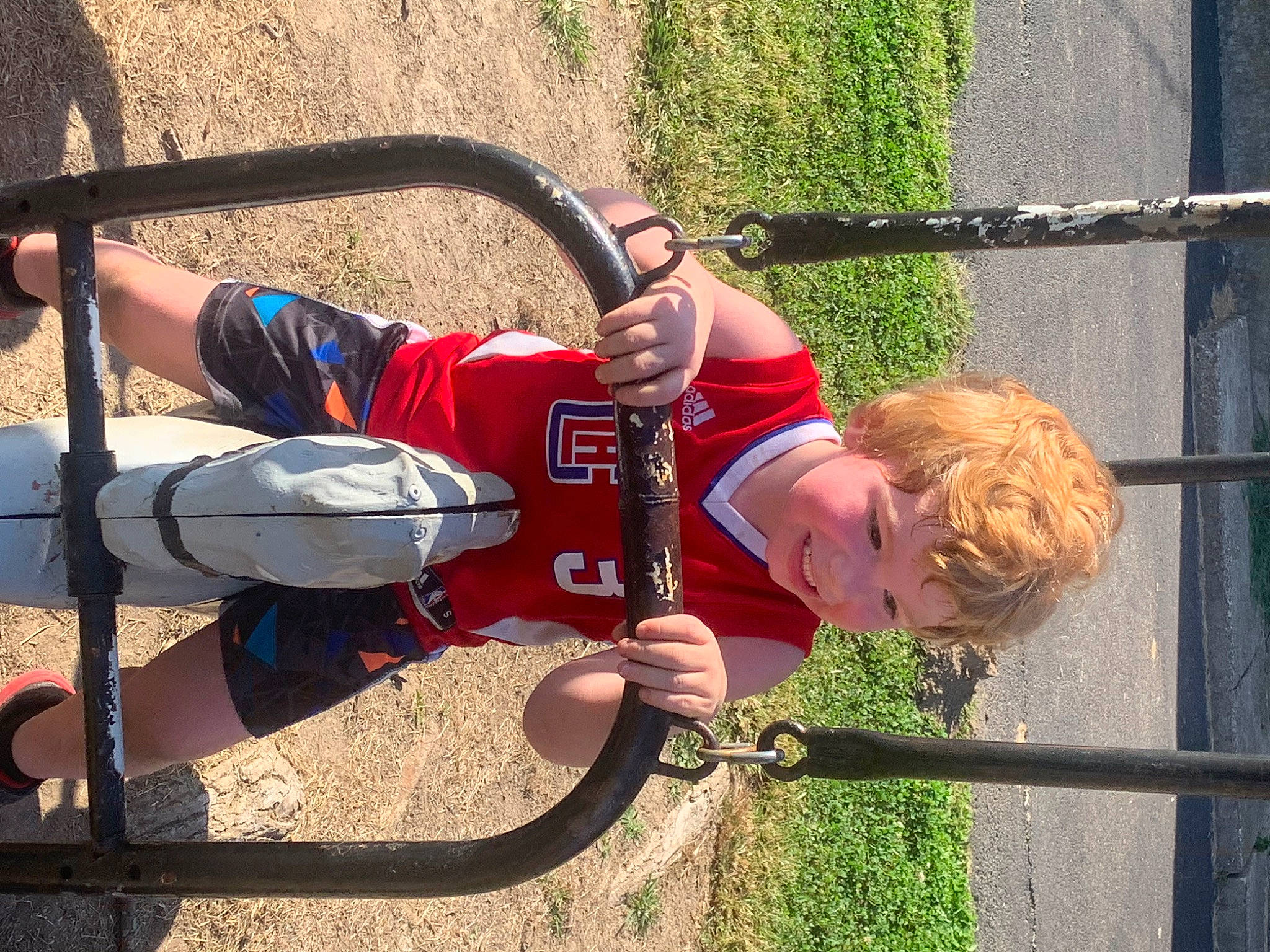 Carson joined the competition — help win amazing prizes! adventure, bicycle_handlebar, child, city, elbow, fence, fun, grass, helmet, joy, leisure, outdoor_play_equipment, person, play, recreation, spoke, steering_wheel, swing, toddler, tree