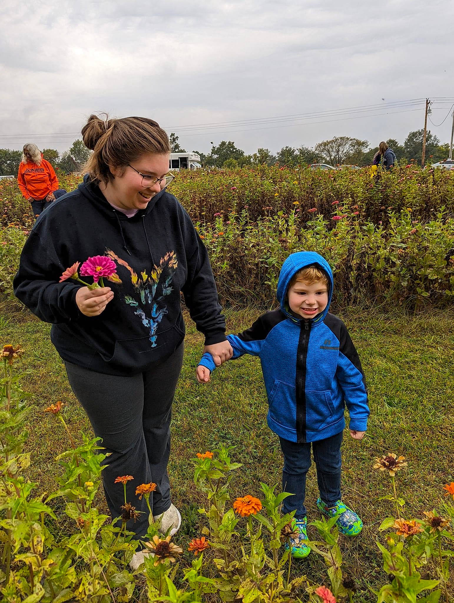 Carson is registered to the contest to win money with this photo: agriculture, cloud, flower, grass, grass_family, grassland, happy, headwear, joy, landscape, leisure, meadow, natural_landscape, people_in_nature, person, plant, prairie, recreation, rural_area, sky