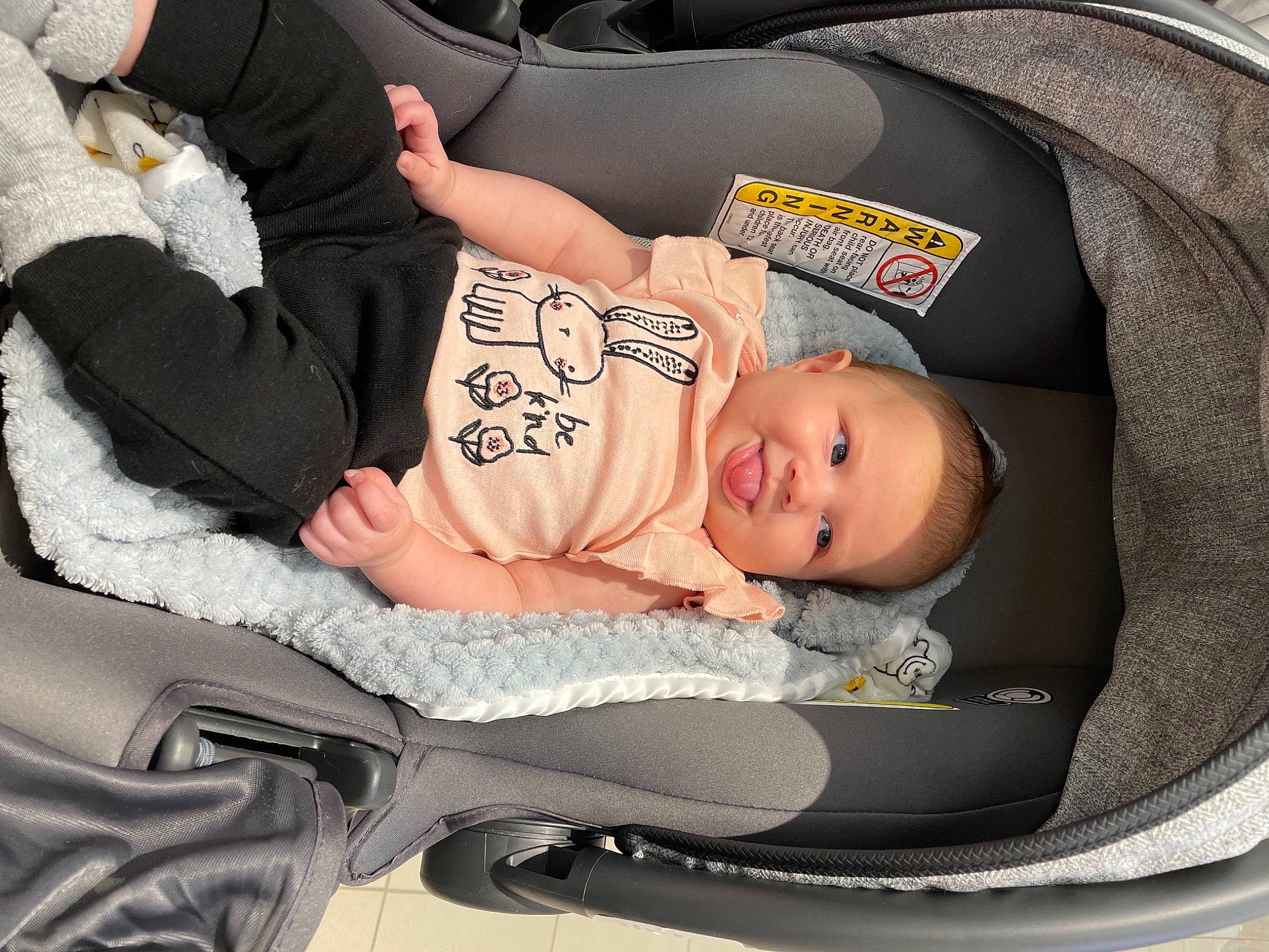 Halle is registered to the contest to win money with this photo: auto_part, baby, baby_carriage, baby_in_car_seat, baby_products, baby_safety, baby_sleeping, baby_toddler_clothing, bag, car_seat, carmine, child, comfort, infant_bed, lap, person, sitting, sleep, toddler