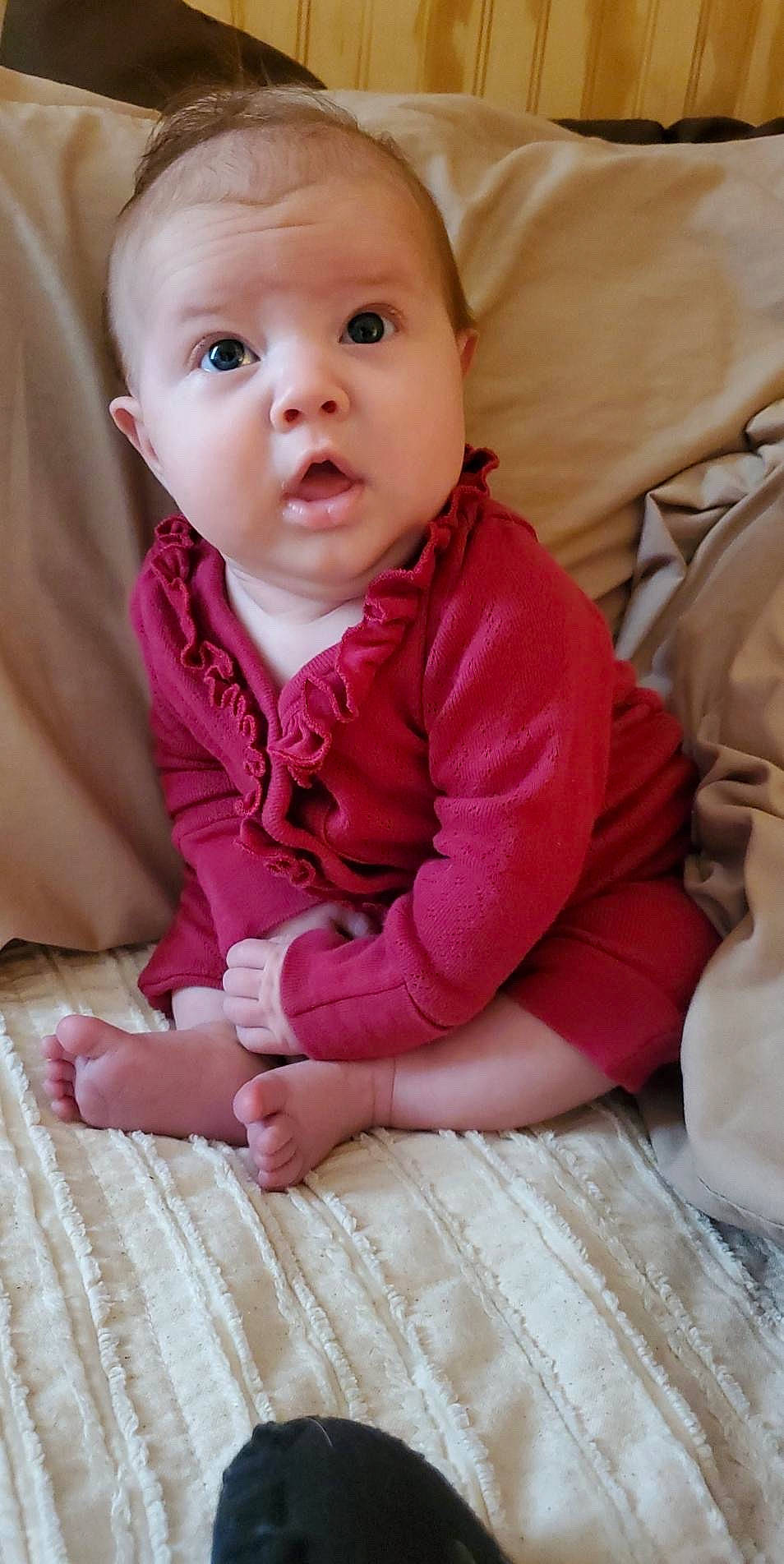 Halle is registered to the contest to win money with this photo: baby, baby_toddler_clothing, cheek, child, comfort, face, finger, flooring, happy, head, human_body, iris, lip, nose, person, pink, skin, sleeve, surprise, textile