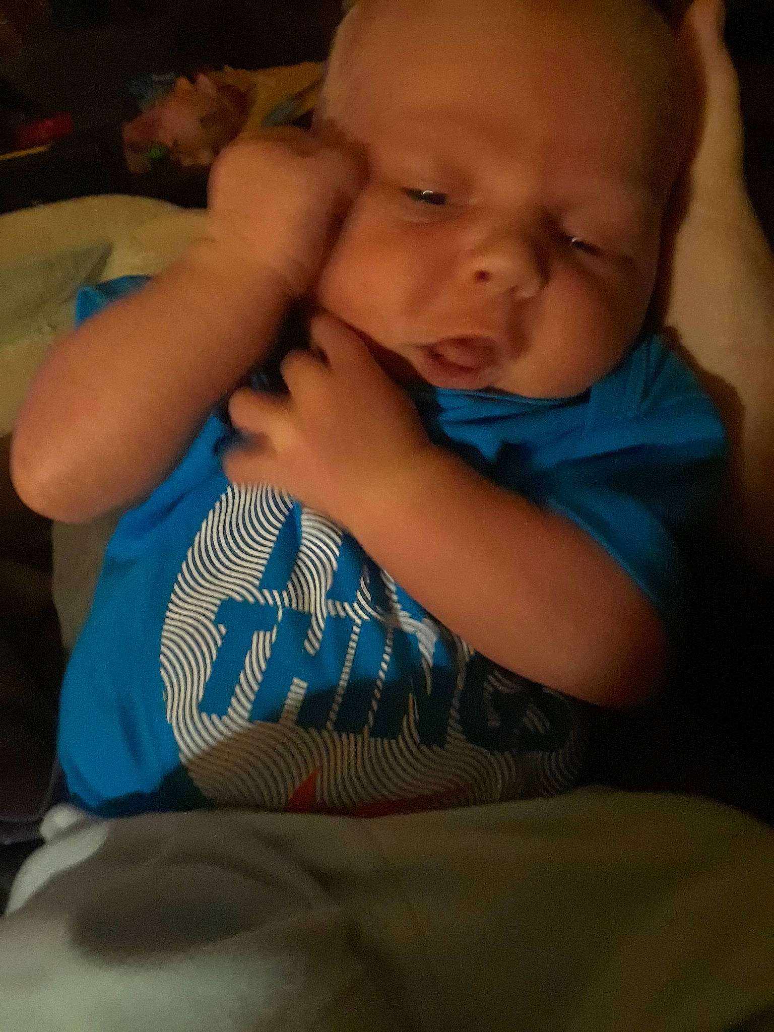 Terrance is registered to the contest to win money with this photo: arm, bedtime, blue, cheek, child, day, eye, face, finger, hand, head, infant, leg, mouth, nose, person, sitting, skin, sleep, toddler