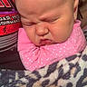 Willow is registered to the contest to win money with this photo: baby, infant, sleeping, pink_clothing, blanket, leopard_print, face, expression, person, indoor, cozy, cute, newborn, child, adult, glasses, phone, casual, portrait, family