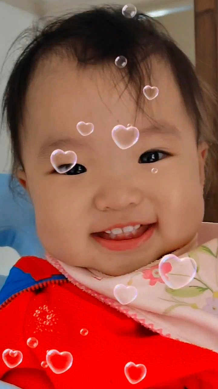 Allison joined the competition — help win amazing prizes! child, toddler, smiling, face, baby, heart_bubble, red_jacket, bib, cute, indoors, portrait, happy, young_child, headshot, black_hair, cheeks, expression, playful, closeup, warm_clothing