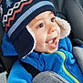 toddler, child, blue_jacket, winter_hat, car_seat, happy, smiling, face, baby, clothing, warm, cozy, seatbelt, transportation, indoors, cute, headwear, expression, joyful, person