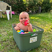 Layton participe au concours pour gagner de l'argent avec cette photo : baby, child, toy, storage_bin, grass, outdoor, nature, play, colorful, water, summer, greenery, plastic, happy, cute, smile, sunlight, fun, garden, relax