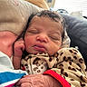 Khelani is registered to the contest to win money with this photo: newborn, baby, sleeping, blanket, leopard_print, hand, face, cozy, indoors, pillow, infant, child, cute, warm, soft, peaceful, portrait, person, rest, closeup