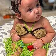 Keomi joined the competition — help win amazing prizes! baby, child, crochet_outfit, handmade, colorful_clothing, sitting, cushion, patterned, curious_look, wet_hair, bracelet, cute, indoors, portrait, closeup, young_child, soft_lighting, skin, face, expression