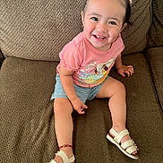 Antonella joined the competition — help win amazing prizes! toddler, child, smiling, sitting, couch, pink_shirt, blue_shorts, white_sandals, happy, indoors, cute, portrait, young_child, face, person, hair_bows, small_earrings, footwear, red_bracelet, casual_clothing