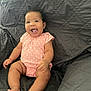 Maylee joined the competition — help win amazing prizes! baby, infant, smiling, tongue_out, pink_onesie, quilted_blanket, happy, cute, chubby_arms, chubby_legs, sitting, indoor, child, person, portrait, skin, face, head, foot, hand