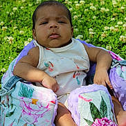 Maylee joined the competition — help win amazing prizes! baby, infant, child, outdoor, grass, flower, greenery, baby_seat, floral_pattern, blanket, sunlight, nature, person, portrait, cute, skin, clothing, summer, relaxing, sitting