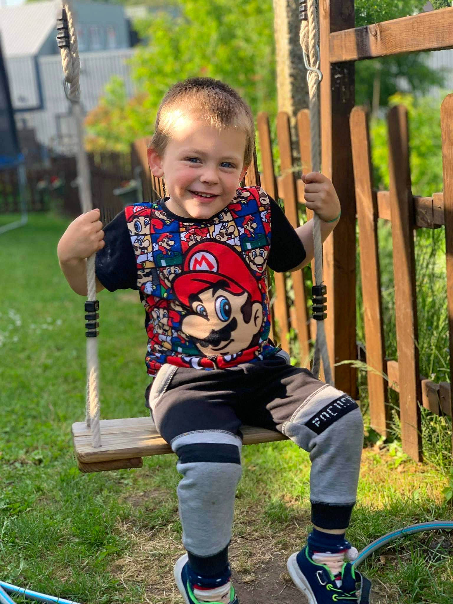 Matheo participe au concours pour gagner de l'argent avec cette photo : child, city, fun, grass, happy, joy, leisure, outdoor_play_equipment, person, plant, product, public_space, recreation, shorts, smile, sneakers, sock, swing, t_shirt, toddler