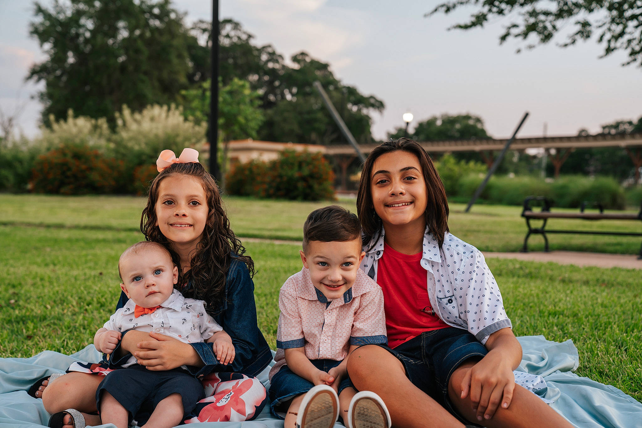 Bennett is registered to the contest to win money with this photo: baby, child, event, facial_expression, fun, grass, happy, joy, leisure, people_in_nature, person, plant, recreation, shorts, sitting, skin, sky, smile, t_shirt, toddler