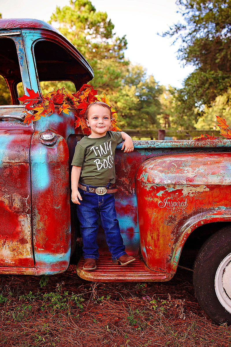 Harvey is registered to the contest to win money with this photo: automotive_design, automotive_exterior, automotive_lighting, automotive_tire, bumper, car, grass, hat, joy, mode_of_transport, motor_vehicle, orange, person, plant, sky, smile, tire, tree, vehicle, vehicle_door