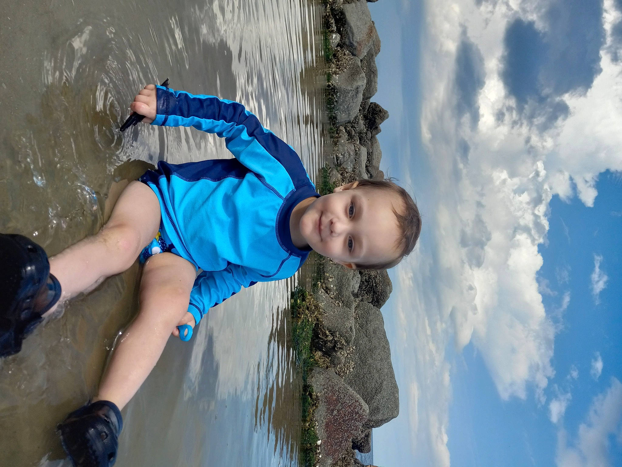 Harvey is registered to the contest to win money with this photo: adventure, azure, boats_and_boating_equipment_and_supplies, body_of_water, child, cloud, cumulus, electric_blue, fun, happy, joy, leisure, people_in_nature, person, recreation, shorts, sky, sport_climbing, toddler, vacation